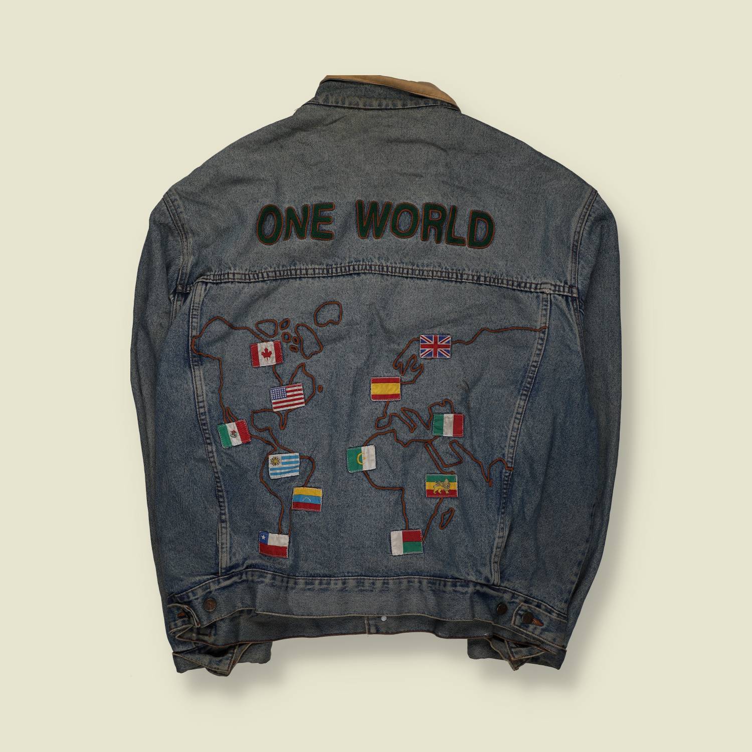 1980s | Custom Denim Jacket | “One World” Embroidered | Blue – XXXXL